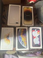 Front view of all five Apple iPhone boxes showing model graphics