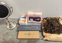 Full lot showing mirror, neck pillow box, Hello Kitty mask box, straightening brush box, Wax Oils box, bag of hair extensions