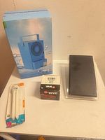 Group shot showing boxed mini air conditioner, sealed antenna, bulb pack, and WVE automotive accessory