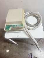 Top view showing ResMed Sullivan Comfort device with attached hose on table