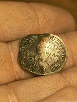 Obverse showing portrait, date 1880 and damaged area