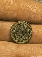 Obverse side showing inscription 1⁄12 ANNA INDIA 1932 with decorative border