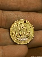Reverse of 1960 half penny showing Golden Hind, gold plating and drilled hole