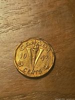 Reverse showing torch, V, CANADA, date 1943