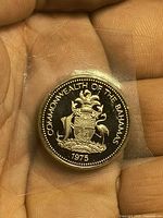 Obverse of 1975 Bahamas proof 25 cents coin in plastic sleeve
