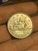 Reverse of 1968 Canadian Voyageur dollar coin showing canoe scene and year