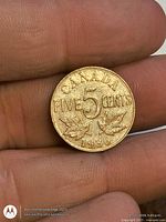 Reverse of 1936 Canada 5 cent coin with maple leaves and denomination