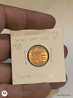 Reverse of 1964 Canadian penny in 2×2 holder showing maple leaves and date