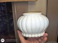 Front view of white milk glass ribbed shade/vase showing ribbed body and beaded base