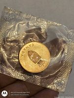 Obverse of sealed medallion showing CANADA and coat of arms