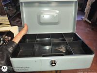 Open cash box showing compartment tray and key