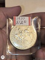 Obverse of 1977 Jubilee crown showing equestrian portrait in plastic flip