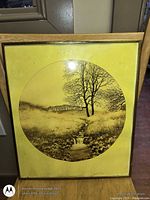 Front view of framed circular landscape print showing frame, mat and artwork