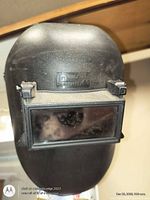 front view of black welding helmet showing rectangular viewing window