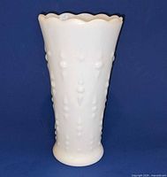 Front view of white milk glass vase with teardrop pattern