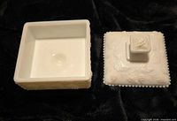 Covered milk glass honey dish showing interior of base and underside of lid