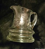 Front angled view showing etched floral design and heavy base