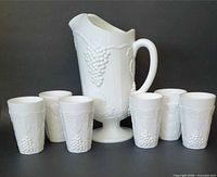 Pitcher with five matching juice glasses displayed