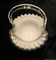 Top view of Fenton Silver Crest milk glass basket showing handle, ruffled clear edge and interior