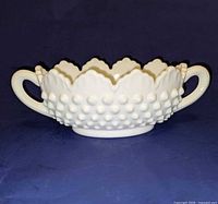 Front view showing hobnail pattern, scalloped rim and both handles