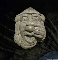 Front view of gray stone-look plaster mask plaque