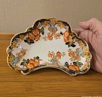 Top view showing full decoration, scalloped rim and gilt trim