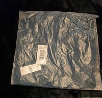 Sealed plastic package containing the top with barcode label