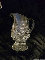 Full side view of clear cut crystal footed creamer