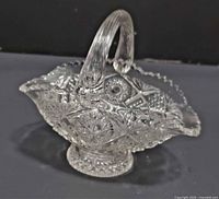 Side view showing hobstar pattern, handle, pedestal base