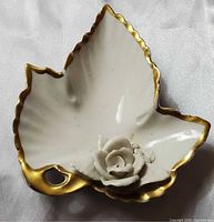 Top view showing leaf shape, rose detail, gold rim
