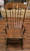 Full view of wooden child's rocking chair showing overall design and condition