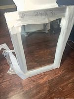 Full view of mirror wrapped in protective material