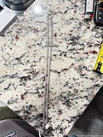 Full view of sterling silver Cuban link chain on countertop