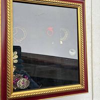 Closed jewelry box showing glass lid and gold trim