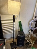 Full view of brown metal floor lamp with shade
