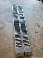 Full view of both steel ramps side by side on floor