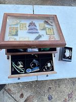 Overall view of jewelry box with glass lid showing brooches in top and drawer open with jewelry, plus separate watch box