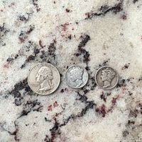 Obverse view of 1954 Washington quarter and two Mercury dimes