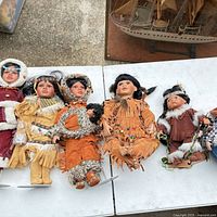 Six porcelain dolls laid on table for group view