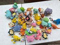 Wide view of all plush dolls spread on table
