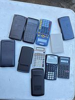 Top view of eight calculators showing brands, models and covers