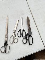 Four pairs of vintage scissors displayed side by side