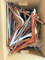 Box filled with wooden hangers, various finishes