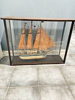 Front view of schooner model inside glass case
