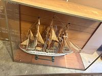 Front view of wooden model ship in display case