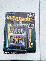 Front of original Buckaroo Slot Bank box