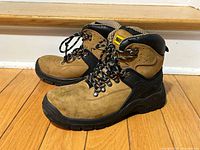 Side view of both boots showing uppers, outsoles, and overall condition