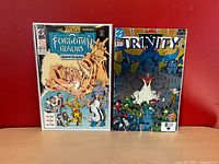 Both comics side-by-side, full front covers in sleeves