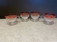 Four Indiana Glass footed cups side by side