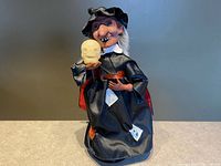 Front view of witch figurine holding skull